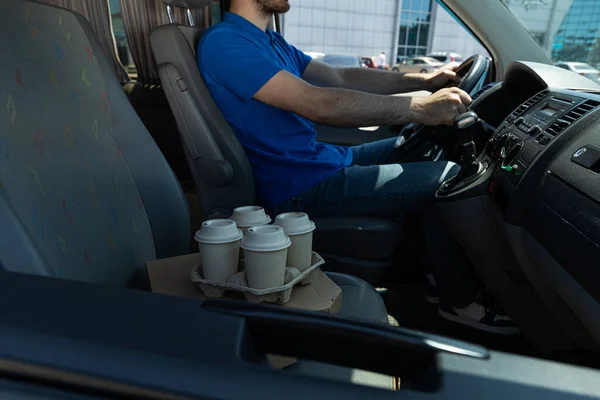 The courier delivers coffee and pizza by car
