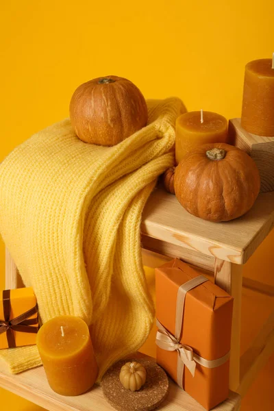 Candles Sweater Pumpkins Wooden Shelves Yellow Background — Stock Photo, Image