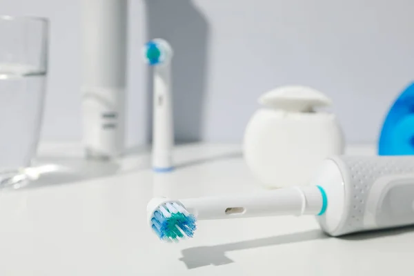 Electric Toothbrushes Table Gray Background Close — Stock Photo, Image