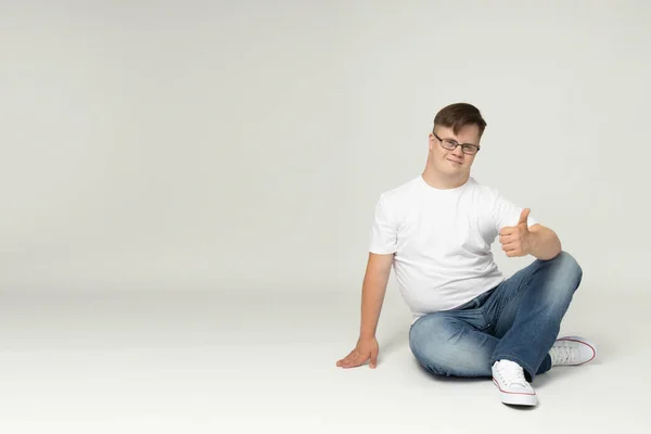 Smiling Young Man Syndrome Glasses Jeans White Shirt Posing Front — Stock Photo, Image