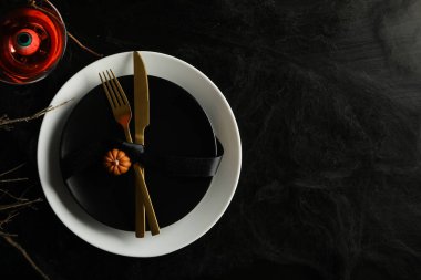 Cadılar Bayramı yemeği için mum ve çatal bıçaklı şenlik masası.