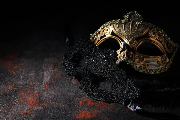 Carnival masks on dark background, space for text