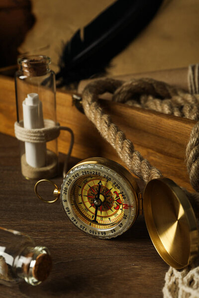 Columbus Day. Vintage compass with rope on table