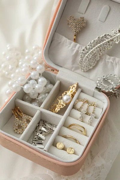 Jewelry box with wedding decorations on white background, close up