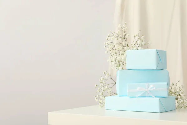 Gift boxes and flowers on white background, space for text