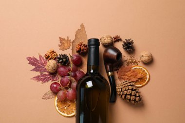 Cam şişe, üzüm ve koni bej arka planda, üst manzara