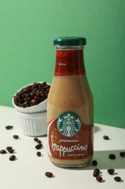 Ukrayna, Kyiv, 24 / 08 / 2023: Starbucks frappuccino şişesi ve yanında kahve çekirdekleri.