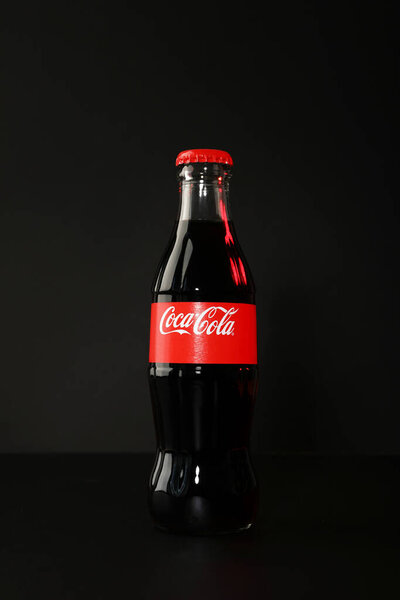 Ukraine, Kyiv, 24/08/2023: The most popular soft drink in the world: Coca Cola, in a glass bottle.