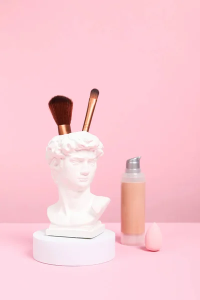 Head of David with pink makeup accessories
