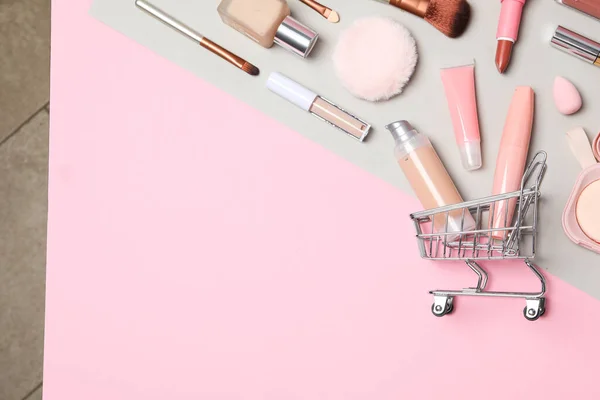 Golden shopping basket with pink makeup accessories