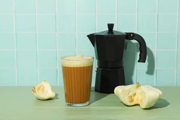 Pumpkin coffee, zucchini and coffee maker on blue background