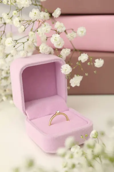 Gold women\'s engagement ring in a soft, velvet case.