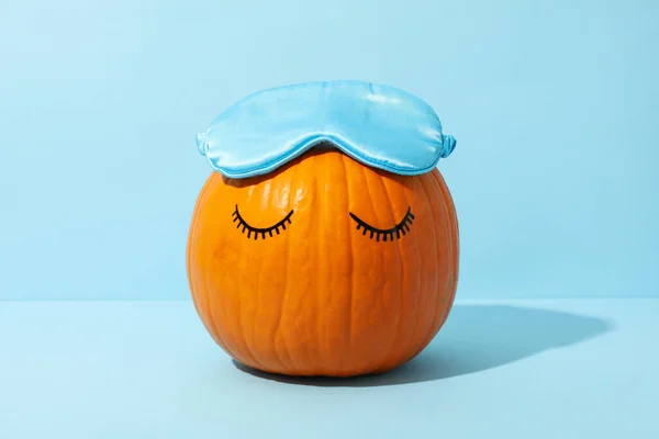 Pumpkin with eyelashes and a sleeping mask