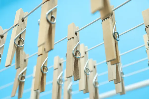 Close-up of wooden clothespins on a drying rack