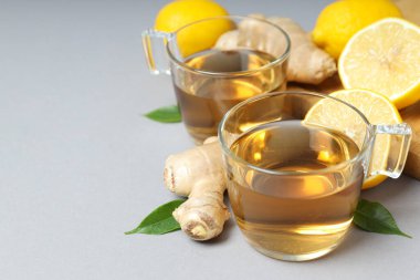 Gri arkaplanda çay, zencefil ve limon, metin için yer
