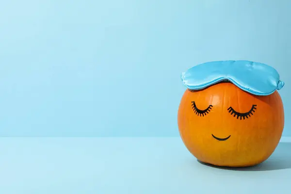 Pumpkin with eyelashes and a sleeping mask