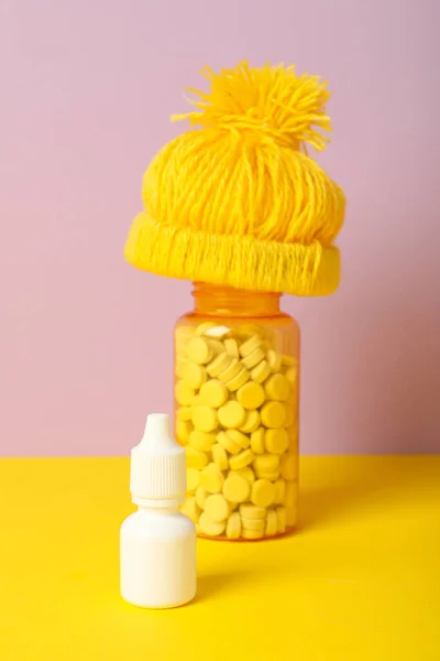 A yellow cap and jars of medicine