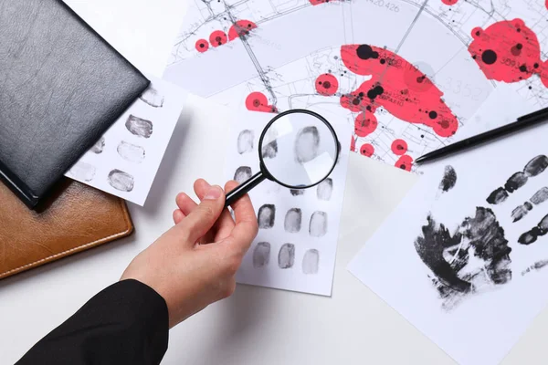 Books, magnifying glass with fingerprints on a white background