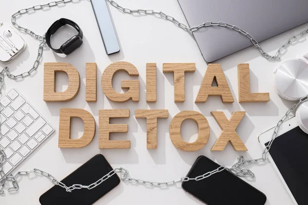 Digital detox concept, gadgets with chain on table