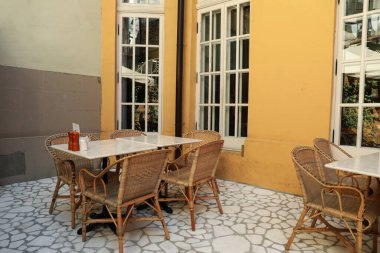 Turuncu duvar, pencereler, masalar ve sandalyeler