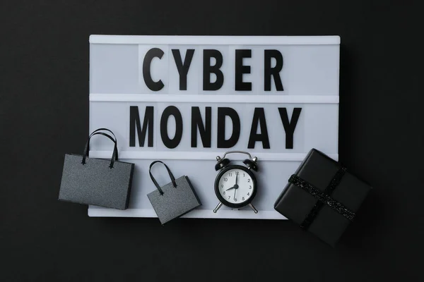 Cyber monday message with packages on dark background.