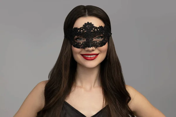Attractive young girl in a black mesh mask