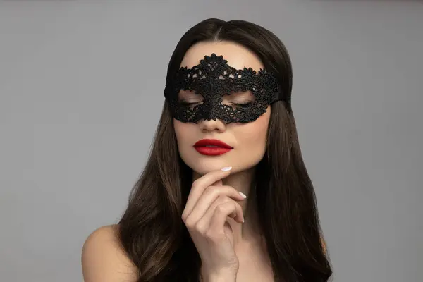 Attractive young girl in a black mesh mask
