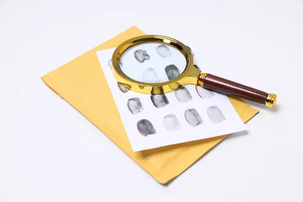 Magnifying glass with fingerprints on a white background