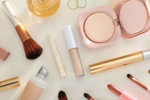 Cosmetics and accessories on a white table
