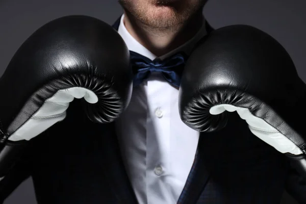 A man in a suit and boxing gloves