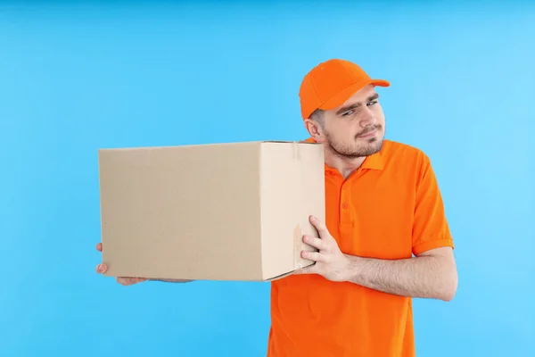 Young attractive guy with a cardboard box in his hands