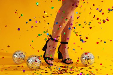 Disko toplarıyla topuklu kadın bacakları