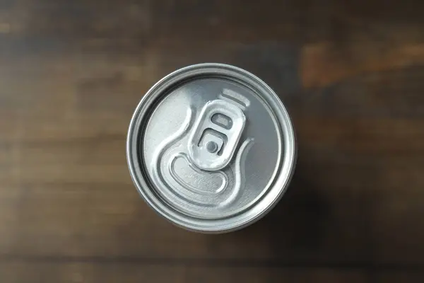 Tin can for drinks on a wooden background