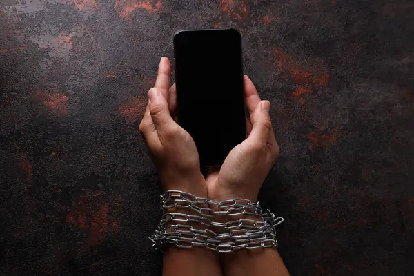 Human hands in a chain with a smartphone