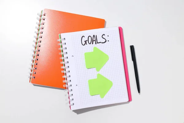 A notebook with a plan of goals and arrows