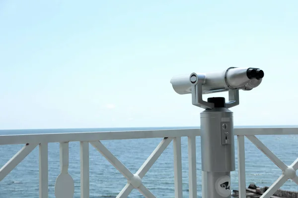 Close-up of white observation binoculars on the embankment