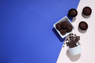 Brigadeiro ve çikolata parçacıkları mavi ve beyaz arka plan, metin için boşluk