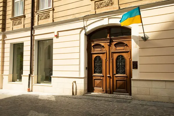 The Ukrainian flag is attached to the old building