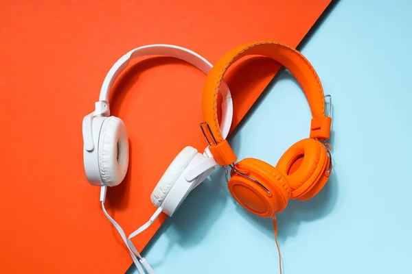 A pair of over-the-ear headphones on a light background.