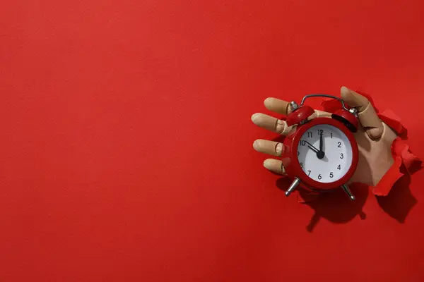 Red alarm clock on a red background