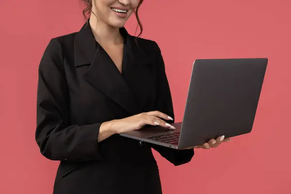 Attractive young business lady with laptop in hands