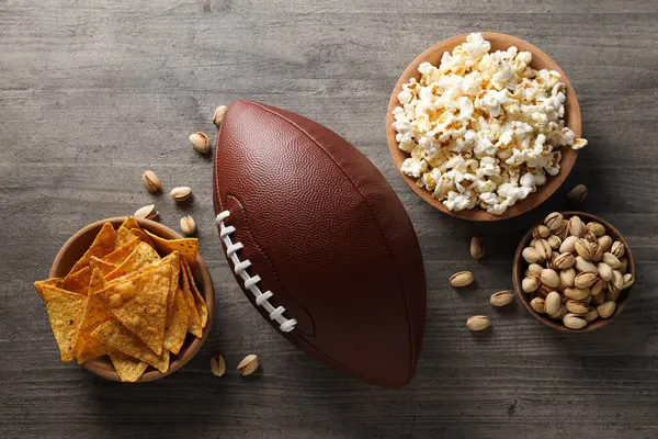 Bowl of chips and popcorn with rugby ball