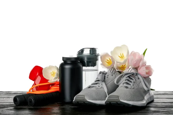 PNG sports goods with flowers on table isolated on white background.