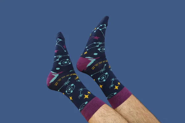Colored socks with a print on men\'s feet.