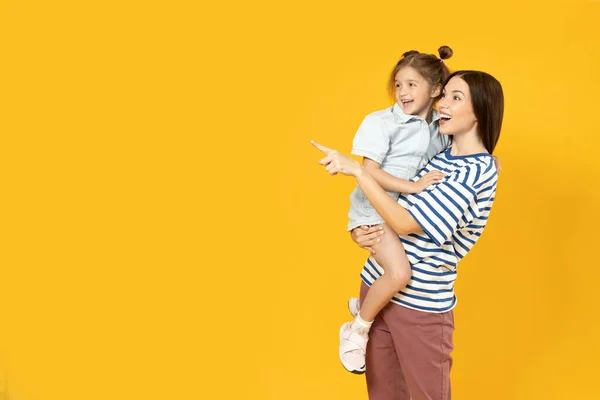 Mother and daughter are talking, on a yellow background.