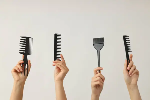 Hairdressing tools and products in female hands.