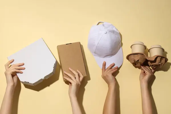 Cardboard boxes for food delivery, in the hands of women.