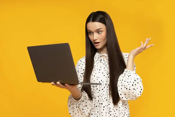 stock image A cute young woman with a laptop in her hands