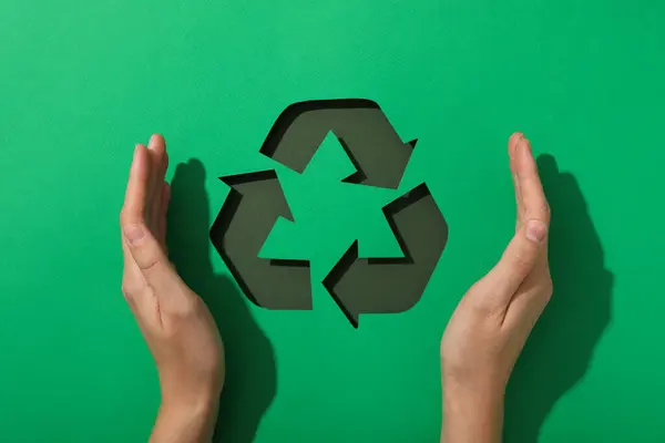 Material recycling sign on a green background