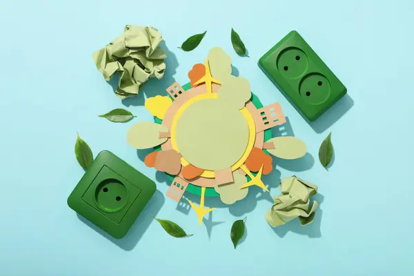 Paper model of the Earth with green electric sockets